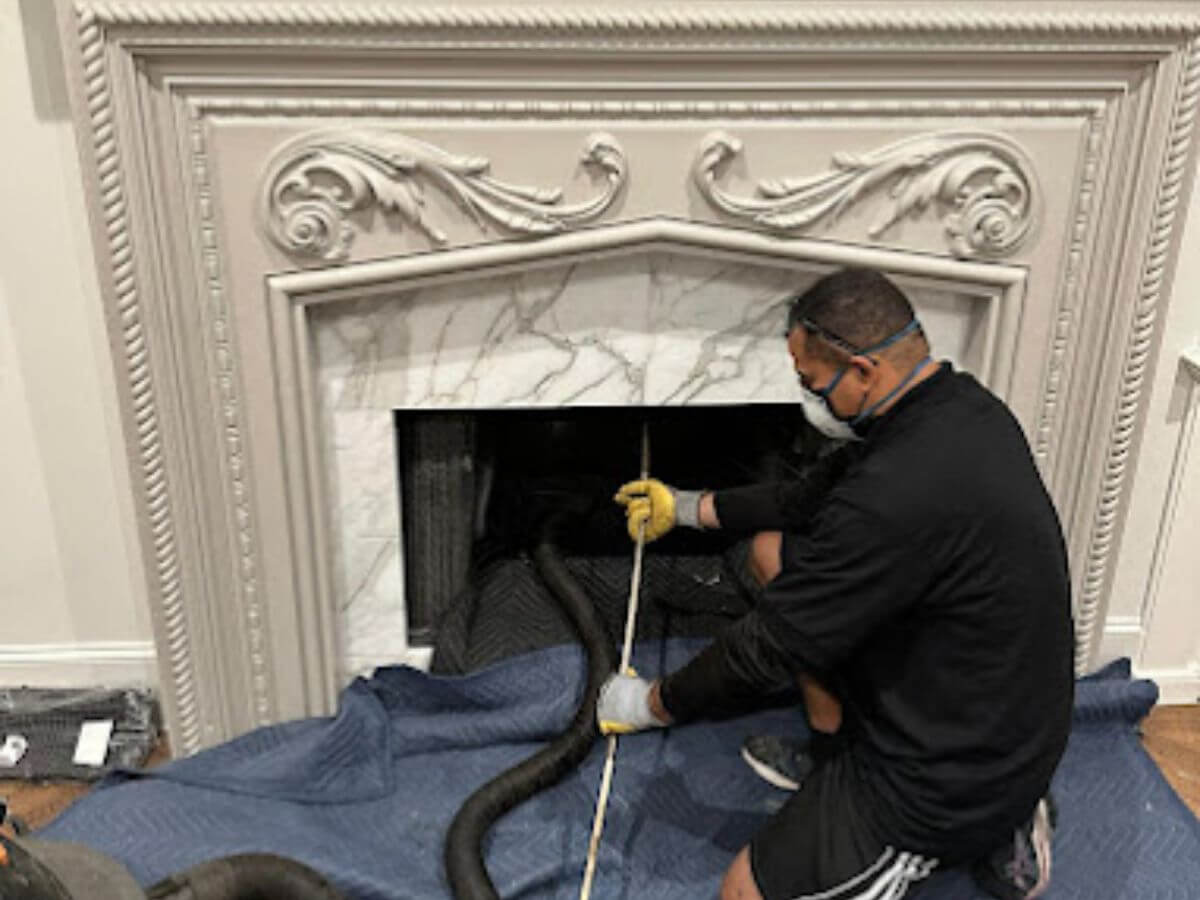 Worker performing chimney sweep Dallas TX